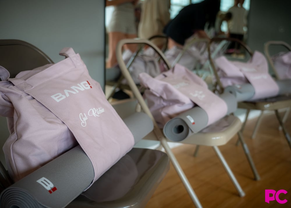 Gal Ritchie's Bang tote bag and yoga mat staged on a folding chair before the music video shoot